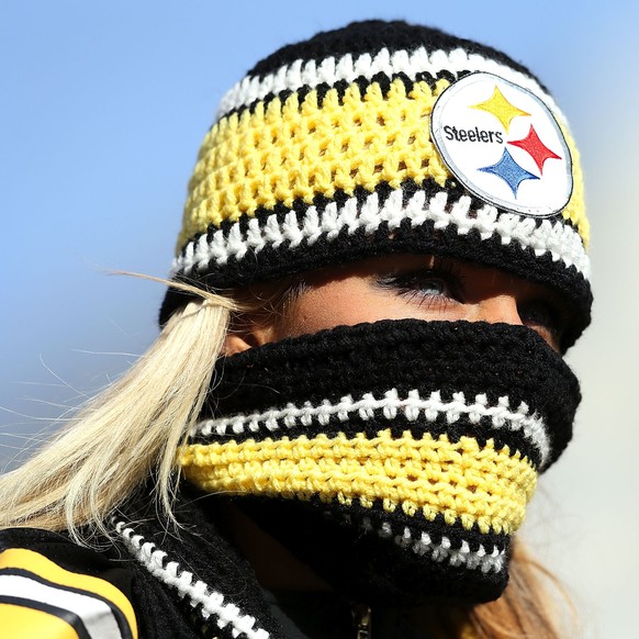 CINCINNATI, OH - DECEMBER 7: A fan of the Pittsburgh Steelers attempts to keep warm while watching the Pittsburgh Steelers warm up prior to the start of the game against the Cincinnati Bengals at Paul ...