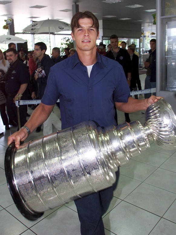Swiss Ice-Hockey goalie David Aebischer holds the Stanley Cup he won with his team Colorado Avalanche, Friday, August 31, 2001 in a car dealer&#039;s garage in Fribourg, Switzerland. Aebischer is the  ...