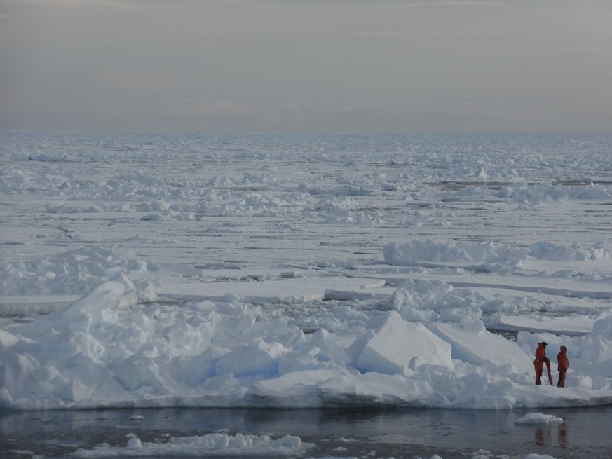 In this image provided by Dirk Notz, taken April 4, 2015, shows people waking on the ice in the Arctic near Svalbard, Norway. At current carbon emission levels, the Arctic will likely be free of sea i ...