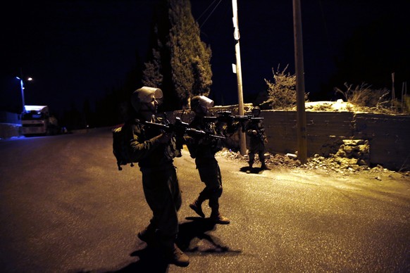 epa05610310 Israeli army soldiers stand guard near the scene of car ramming attack in the West bank village of Beit Ommar, north of Hebron, 30 October 2016. Israeli troops shot and killed 25-year old  ...