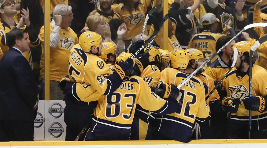 Nashville Predators players celebrate after Calle Jarnkrok, not shown, scored an empty-net goal against the St. Louis Blues during the third period in Game 6 of a second-round NHL hockey playoff serie ...