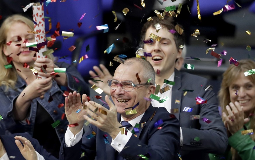 Green Party&#039;s gay rights activist Volker Beck, center, and fellow faction members celebrate with a confetti popper after German Federal Parliament, Bundestag, voted to legalize same-sex marriage  ...