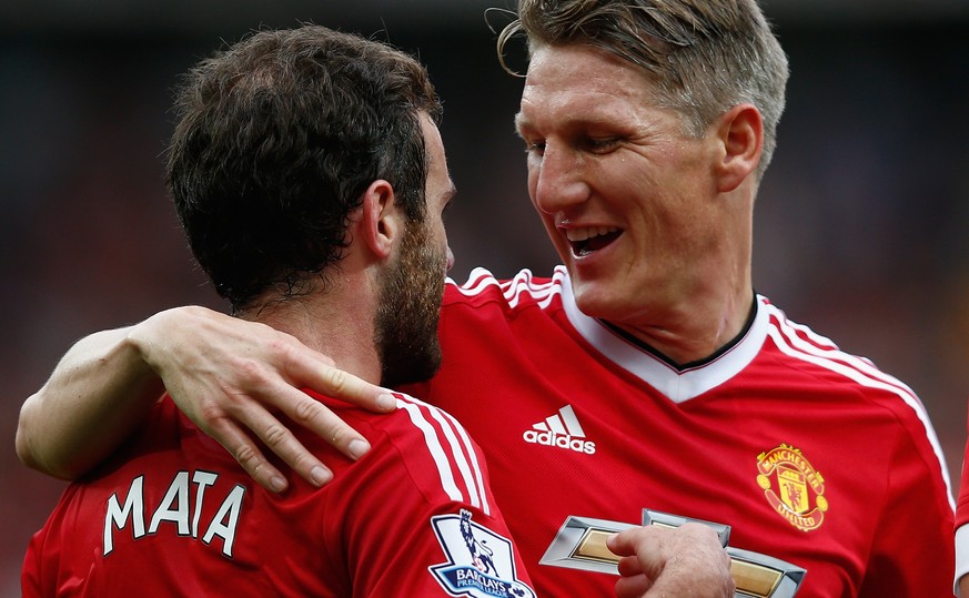 MANCHESTER, ENGLAND - SEPTEMBER 26: Juan Mata (L) of Manchester United celebrates scoring his team&#039;s third goal with his team mate Bastian Schweinsteiger (R) during the Barclays Premier League ma ...