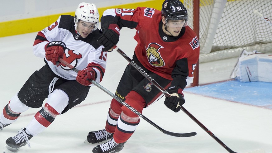Ottawa Senators&#039; Logan Brown, right, is checked by New Jersey Devils&#039; Nico Hischier, of Switzerland, during the third period of an NHL preseason hockey game in Summerside, Prince Edward Isla ...
