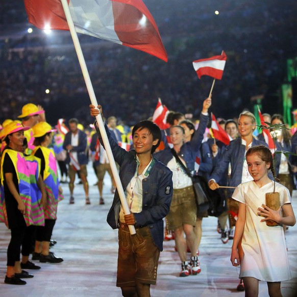 epa05457186 Flag bearer Liu Jia (C) of Austria leads her team into the Maracana Stadium during the Opening Ceremony of the Rio 2016 Olympic Games in Rio de Janeiro, Brazil, 05 August 2016. EPA/SERGEY  ...