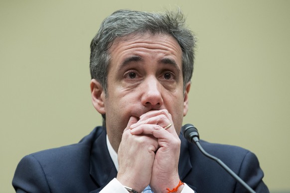 epa08434709 (FILE) - Michael Cohen, former attorney to US President Donald J. Trump, reacts while listening to the closing remarks of House Oversight and Reform Committee Chairman Elijah Cummings, whi ...