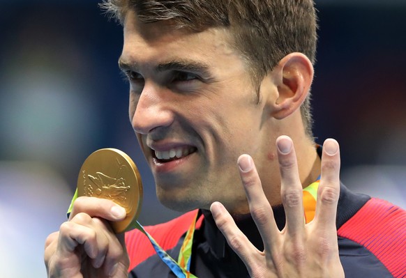 United States&#039; Michael Phelps celebrates winning the gold medal in the men&#039;s 200-meter individual medley during the swimming competitions at the 2016 Summer Olympics, Thursday, Aug. 11, 2016 ...