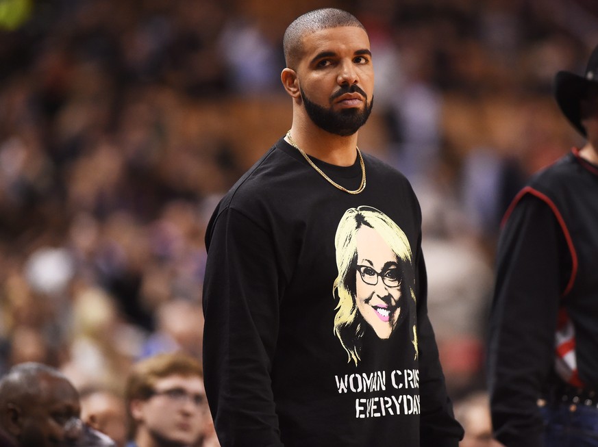 Rapper Drake watches the second half of an NBA basketball game between the Golden State Warriors and the Toronto Raptors on Wednesday, Nov. 16, 2016, in Toronto. (Frank Gunn/The Canadian Press via AP)