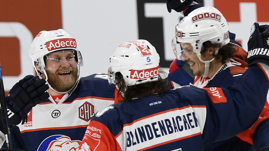 Zurich&#039;s scorer Roman Wick, right, Severin Blindenbacher, center, and Patrick Thoresen, left, celebrate their victory in the ice hockey Champions League match 1/8 Final between ZSC Lions and HC L ...