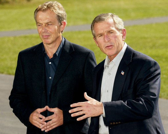 FILE - In this Saturday, Sept. 7, 2002 file photo, President George Bush welcomes British Prime Minister Tony Blair as he arrives for talks at Camp David, Maryland, USA. Blair&#039;s decision to back  ...