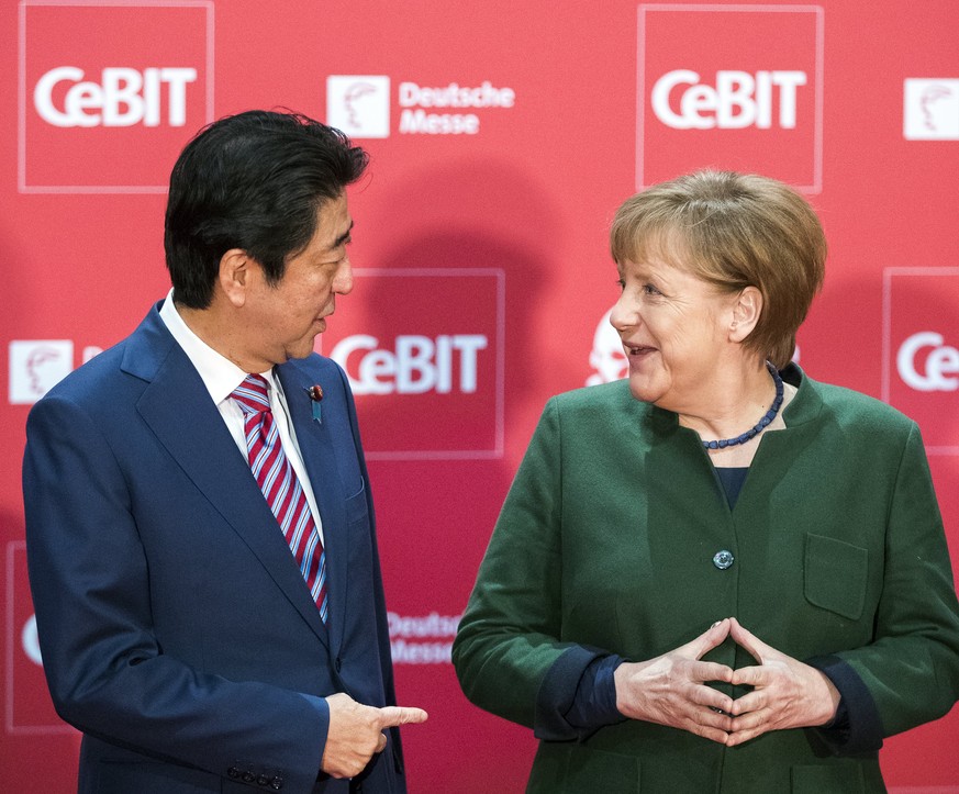 epa05858686 Japanese Prime Minister Shinzo Abe (L) and German Chancellor Angela Merkel (R) chat as they take their position for a group photo during the &#039;Welcome Night&#039; opening event at the  ...