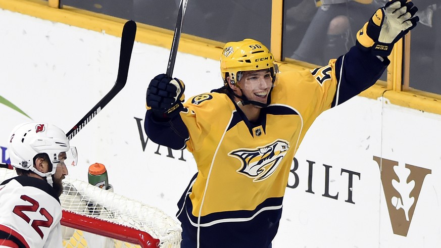 Nashville Predators left wing Kevin Fiala, right, of Czech Republic, celebrates after scoring a goal against the New Jersey Devils during the first period of an NHL hockey game, Saturday, Dec. 3, 2016 ...