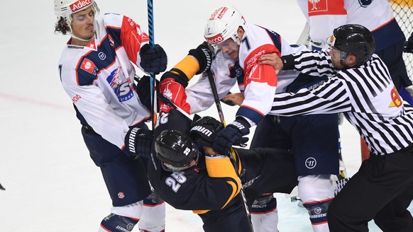 Zurich&#039;s Roman Wick, Lugano’s Maxim Lapierre, and Zurich&#039;s David Rundblad, from left, fight for the puck during a Champions Hockey League round of 16 match between Switzerland&#039;s HC Luga ...
