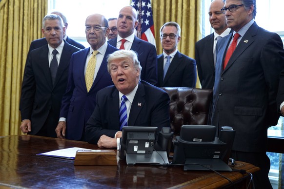 FILE - In this March 24, 2017, file photo, President Donald Trump announces the approval of a permit to build the Keystone XL pipeline, clearing the way for the $8 billion project in the Oval Office o ...