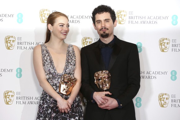 Actress Emma Stone with her BAFTA award for Best Actress and director Damien Chazelle with his BAFTA award for Best Director both for the film &quot;La La Land&#039; pose backstage at the British Acad ...