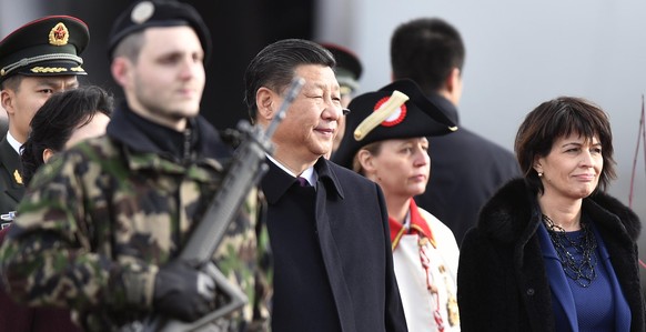 China&#039;s President Xi Jinping, center, and Swiss Federal President Doris Leuthard, right, inspect the honour guard during the arrival ceremony for Xi&#039;s two days state visit to Switzerland at  ...