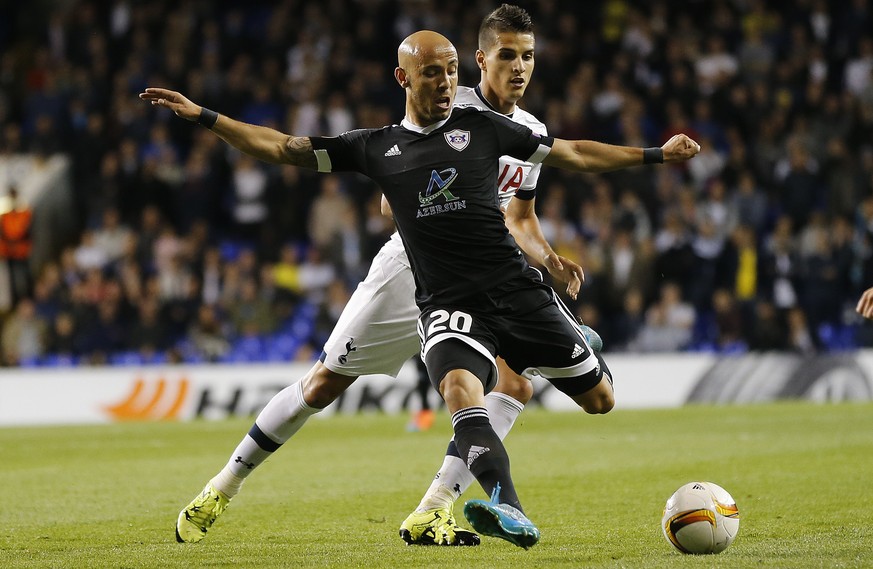 Tottenhams Erik Lamela, rear, and Qarabags Richard Almeida challenge for the ball during the Europa League Group J soccer match between Tottenham Hotspur and Qarabag FK at the White Hart Lane stadiu ...