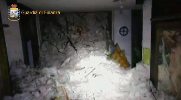 epa05732080 A handout photo made available by the Italian Guardia di Finanza showing snow fill up the interior of the hotel Rigopiano in the town of Farindola, overwhelmed the previous night by a snow ...
