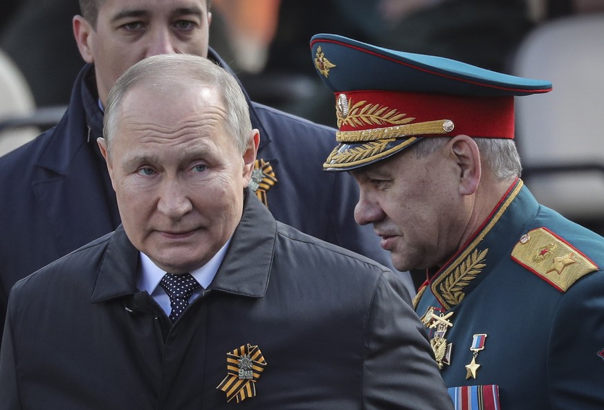 epa09935430 Russian President Vladimir Putin (L) and Russian Defense Minister Sergei Shoigu leave the Red Square after the Victory Day military parade in Moscow, Russia, 09 May 2022. Russia marks Vict ...
