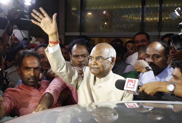 FILE- In this June 19, 2017, file photo, Ram Nath Kovind, center, waves to media upon arrival at the airport in New Delhi, India. Kovind, 71, a Hindu nationalist leader has been elected India&#039;s n ...