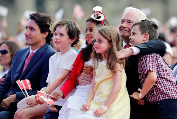 Canada&#039;s Governor General David Johnston (2nd R) sits with his grandchildren as he attends Canada Day celebrations with Canada&#039;s Prime Minister Justin Trudeau (L) on Parliament Hill in Ottaw ...