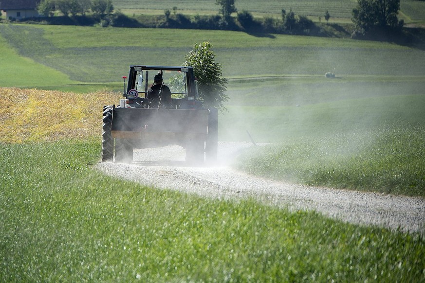 Ein Bauer mit dem Traktor unterwegs auf&#039;s Feld am Dienstag 3. September 2013 auf der Ahornalp. (KEYSTONE/Marcel Bieri)