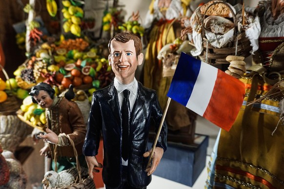 epa05952129 The figurine of French President-elect Emmanuel Macron is on display in a workshop at San Gregorio Armeno street in Naples, southern Italy, 09 May 2017. Via San Gregorio Armeno is a street ...