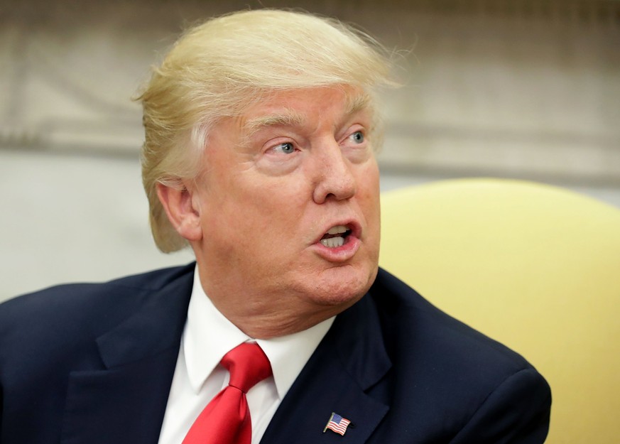 epa05879755 US President Donald J. Trump answers reporters&#039; questions during a photo opportunity with Prime Minister Of Denmark Lars Lokke Rasmussen in the Oval Office at the White House in Washi ...