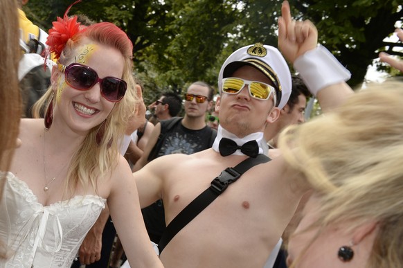 Fancy dressed participants of the annual Street Parade celebrate and dance in the city center of Zurich, Switzerland, Saturday, August 2, 2014. Hundreds of thousands of ravers participate in the event ...