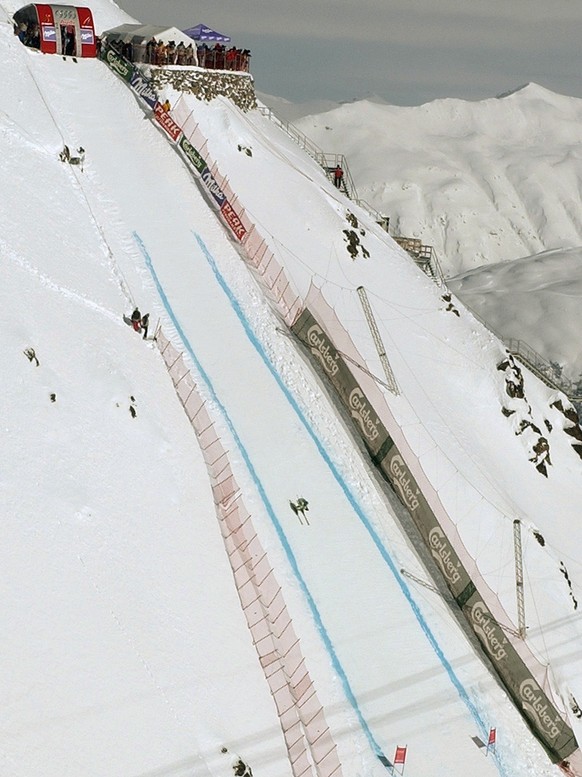 A skier races down the vertical drop of the start area of the men&#039;s second downhill training, at the Alpine Ski World Championships in St. Moritz, Switzerland, Friday, February 7, 2003. (KEYSTONE ...