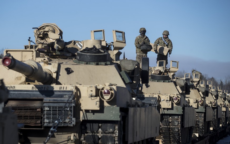 Members of US Army&#039;s 4th Infantry Division 3rd Brigade Combat Team 68th Armor Regiment 1st Battalion prepare to unload some Abrams battle tanks after arriving at the Gaiziunai railway station, so ...