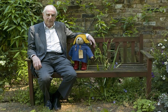 FILE - In this Thursday, June 5, 2008 file photo, British author Michael Bond sits with a Paddington Bear toy during an interview with The Associated Press in London. Publisher HarperCollins says Mich ...