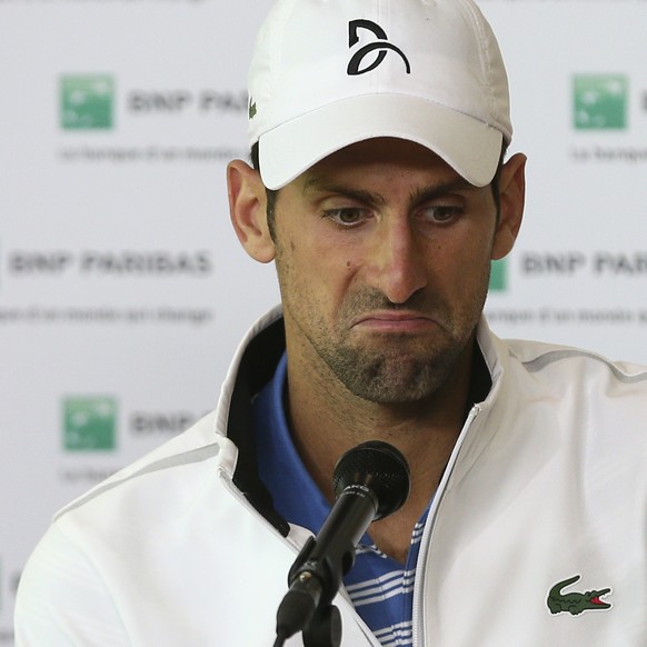 Serbia&#039;s Novak Djokovic grimaces during a press conference after losing to Austria&#039;s Dominic Thiem in a quarterfinal match of the French Open tennis tournament at the Roland Garros stadium,  ...