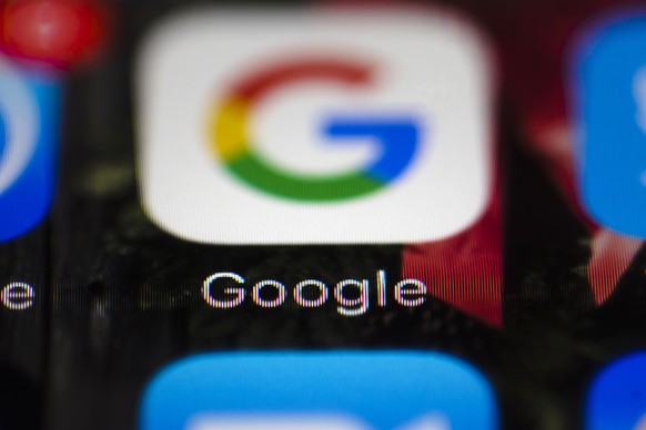FILE- This April 26, 2017, file photo shows a Google icon on a mobile phone in Philadelphia. Google is spearheading an educational campaign to teach pre-teen children how to protect themselves from sc ...