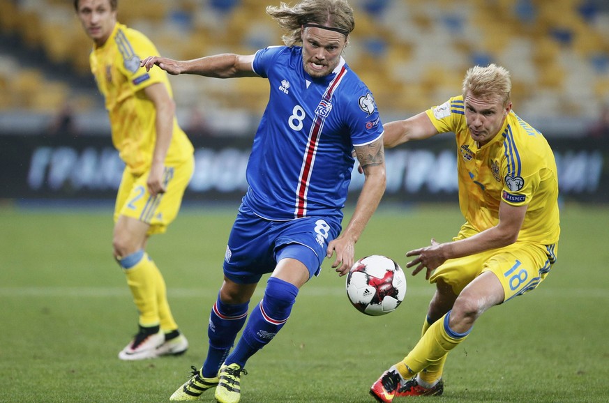 Football Soccer - Ukraine v Iceland - World Cup 2018 Qualifiers - NSC Olimpiyskiy Stadium, Kiev, Ukraine - 5/9/16 - Iceland&#039;s Birkir Bjarnason in action against Ukraine&#039;s Viktor Kovalenko. R ...