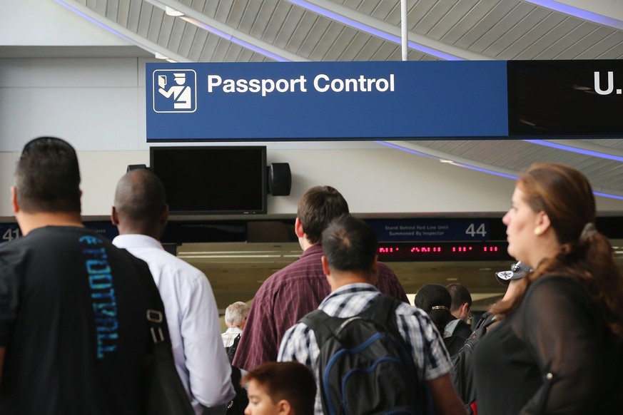 CHICAGO, IL - SEPTEMBER 19: International travelers wait to have their passports checked at O&#039;Hare International Airport on September 19, 2014 in Chicago, Illinois. OHare is the first airport in  ...