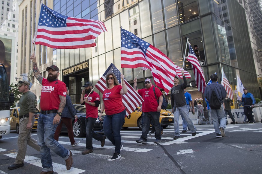 Demonstrators march across Fifth Avenue during a rally near Trump Tower, Saturday, June 3, 2017, in New York. The rally in support of President Trump and his policy to build a wall on the Mexican bord ...