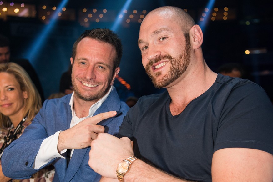 epa05568183 (FILE) A file photograph showing British heavyweight boxing World Champion Tyson Fury (R) with German boxing Promoter Karl-Robin ·Kalle· Sauerland (C) and Nathalie Sauerland (L) in the aud ...