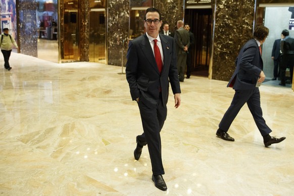 Steven Mnuchin, national finance chairman of President-elect Donald Trump&#039;s campaign, walks in the lobby of Trump Tower, Monday, Nov. 14, 2016, in New York. (AP Photo/ Evan Vucci)