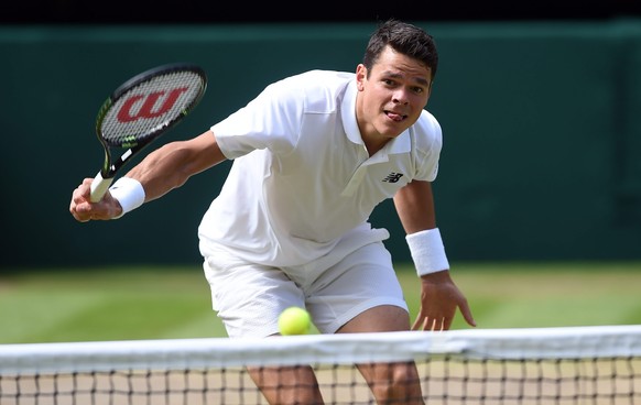 epa05418505 Milos Raonic of Canada returns to Andy Murray of Britain in the men&#039;s singles final of the Wimbledon Championships at the All England Lawn Tennis Club, in London, Britain, 10 July 201 ...