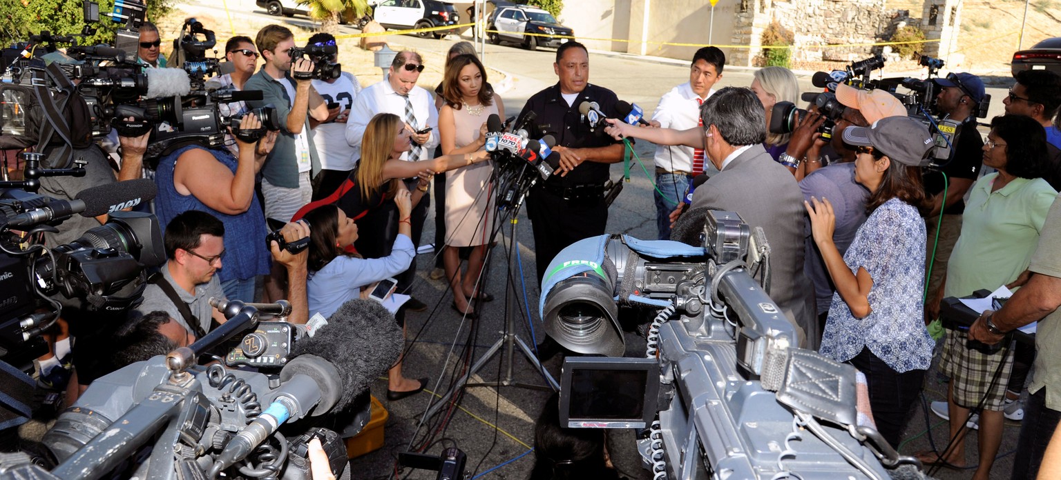 Los Angeles Police Department representative briefs the media after Chris Brown was driven away and hidden from the media gathered as they waited outside the home of singer Chris Brown following an ea ...