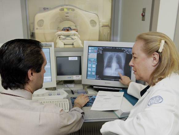 FILE - In this Friday, Aug. 12, 2005 file photo, Dr. Claudia Henschke, chief of the Division of Chest Imaging, right, and CT supervisor Gus Daphnis watch the lung scan of a patient at New York Hospita ...