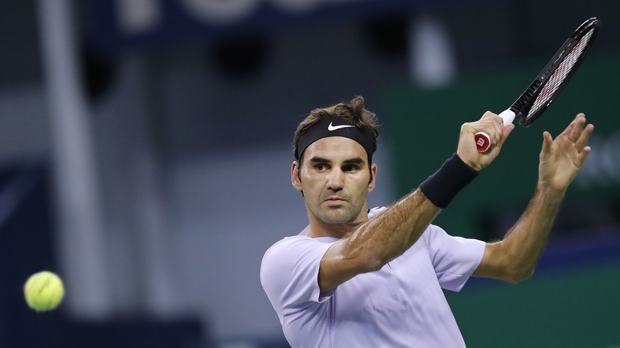 Roger Federer of Switzerland prepares to hit a backhand shot to Diego Schwartzman of Argentina during their men&#039;s singles match in the Shanghai Masters tennis tournament at Qizhong Forest Sports  ...