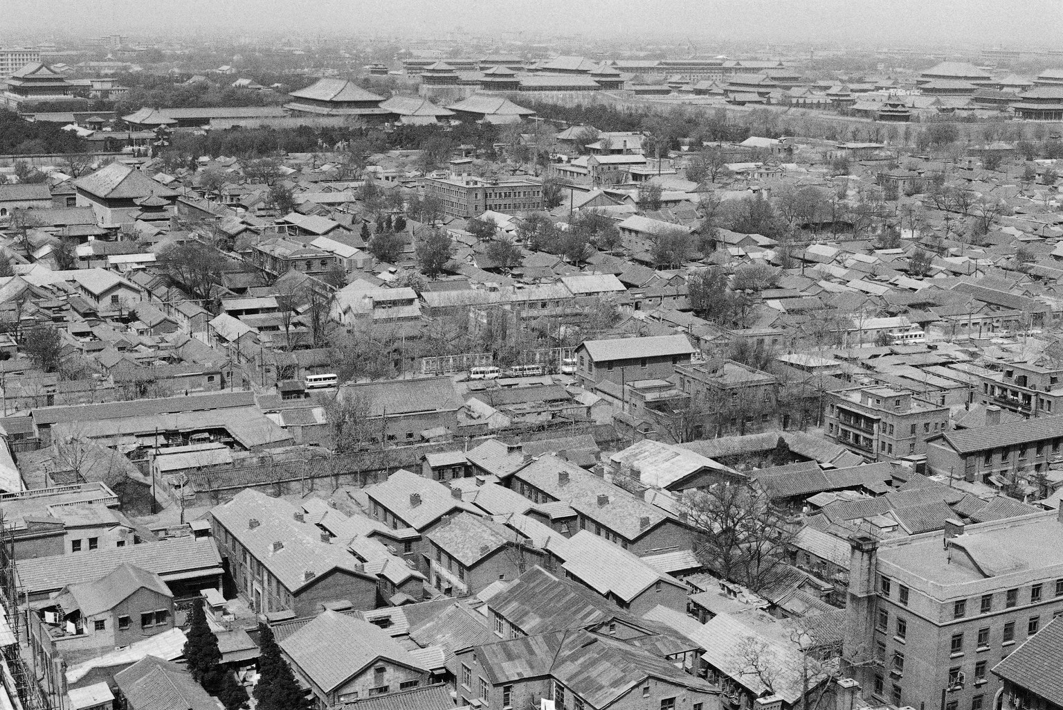 Old courtyards dating back centuries, newer construction and, in the distance, the imposing roofs of old China&#039;s imperial city mark the scene in this aerial view of Beijing, May 7, 1979. (AP Phot ...