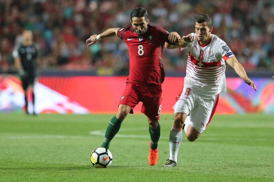 epa06257465 Portuguese player Joao Moutinho (L) in action against Swiss Remo Freuler during the Russia 2018 World Cup qualifier match Portugal vs Switzerland at Luz Stadium in Lisbon, Portugal, 10 Oct ...