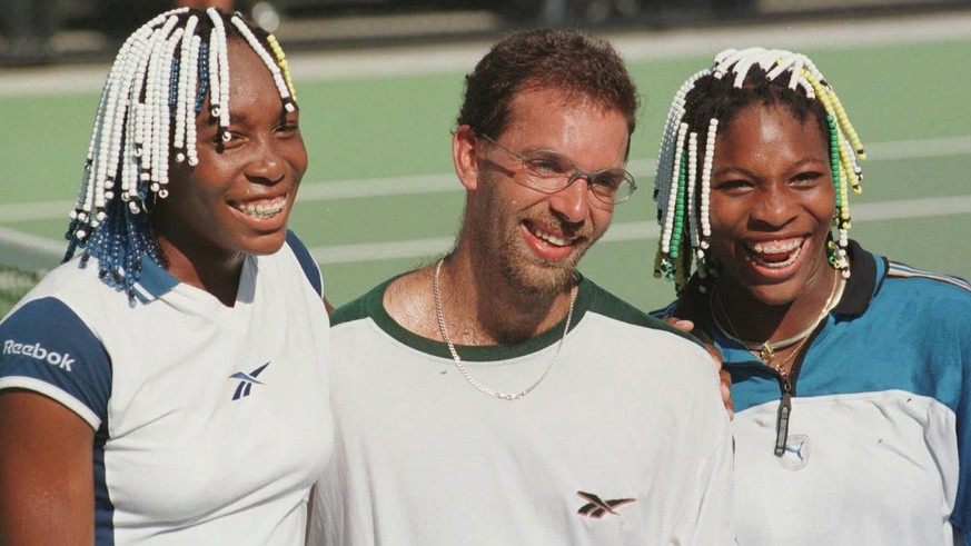 German tennis player Karsten Braasch, from Marl, center, who is currently ranked 203rd in the world, poses on court with American sisters Venus Williams, left, and Serena Williams after playing the gi ...