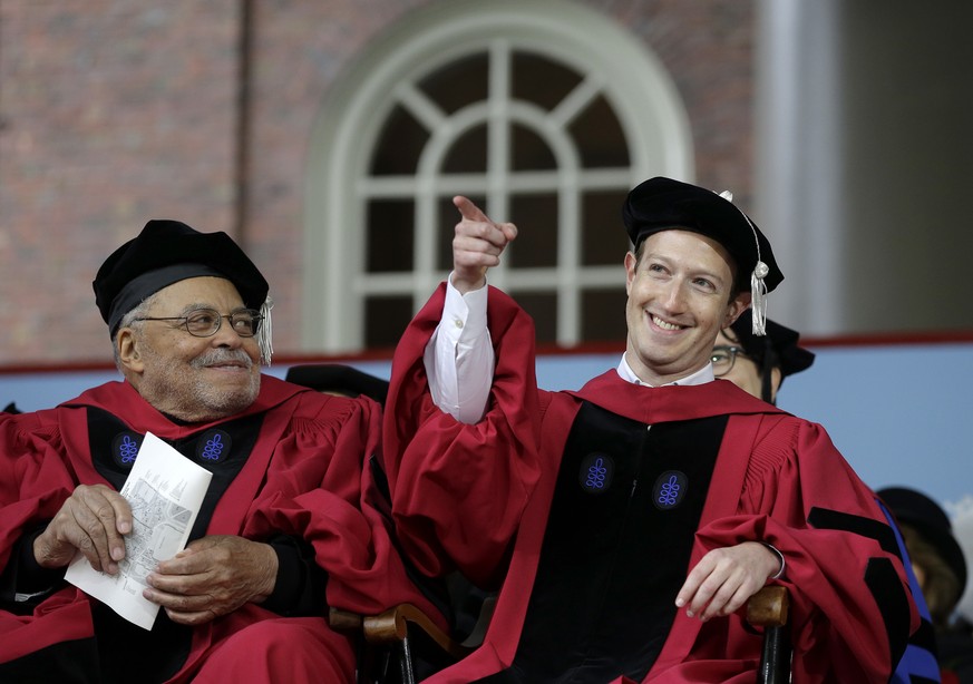 Facebook CEO and Harvard dropout Mark Zuckerberg, right, gestures as actor James Earl Jones, left, looks on while seated on stage during Harvard University commencement exercises, Thursday, May 25, 20 ...