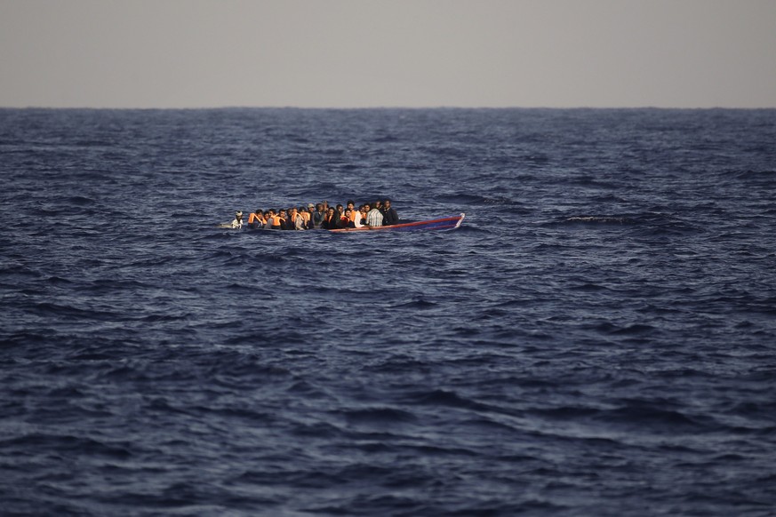 Migrants and refugees fleeing Libya on board of a wooden boat sail at the Mediterranean sea toward the Italian coasts, about 17 miles north of Sabratha, Libya, Sunday, Aug. 28, 2016. European nations  ...