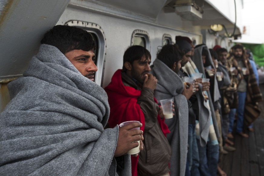 Migrants have breakfast aboard Golfo Azurro boat a day after being rescued by members of Proactiva Open Arms NGO, Friday, April 7, 2017. The Spanish charity says it has rescued 230 migrants, from Afri ...