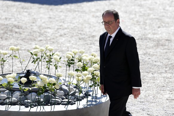 epa05586261 French President Francois Hollande walks past white roses representing each of the victims during the national ceremony to pay tribute to the victims of the 14 July terror attack in Nice,  ...